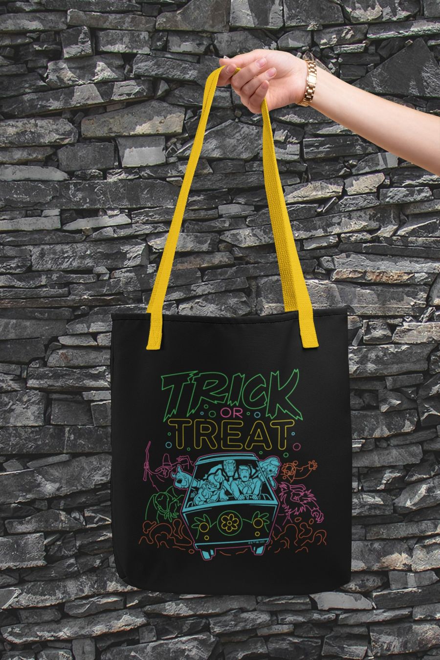 SD-Scoobtober_brick-mockup-of-a-hand-holding-a-customizable-strap-tote-bag-against-a-flat-surface-28832