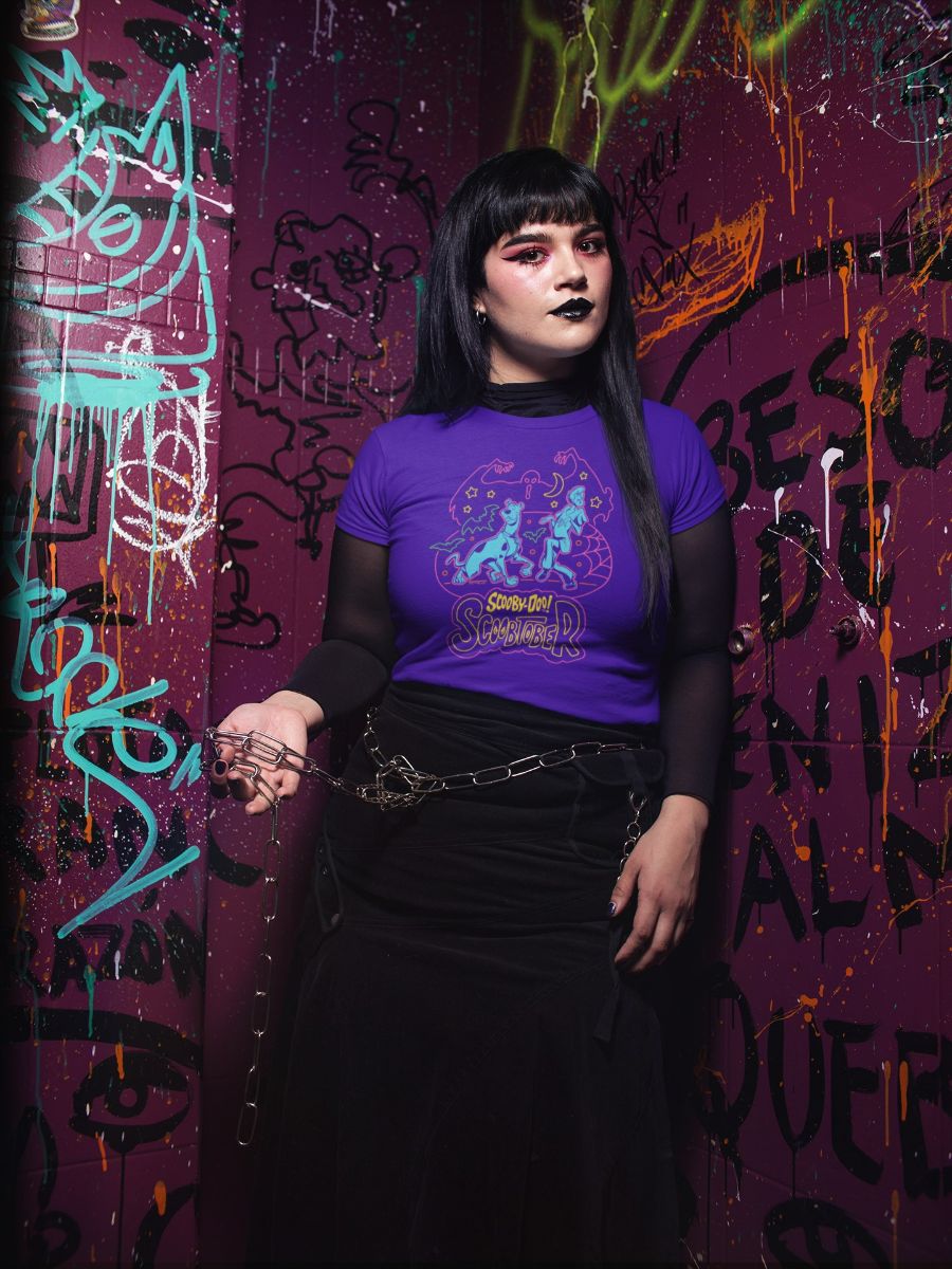 SD-Scoobtober_t-shirt-mockup-of-an-edgy-goth-woman-standing-in-a-neon-graffiti-corner-26607