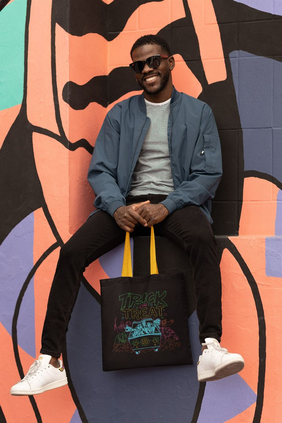 SD-Scoobtober_tote-bag-mockup-featuring-a-cheerful-man-posing-behind-a-colorful-wall-m28701